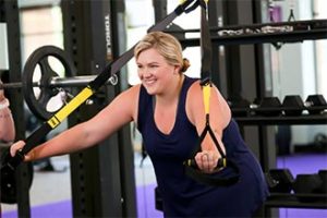Woman working out with trx bands