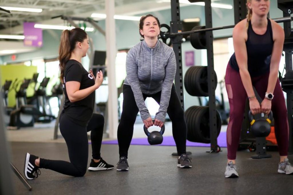 coach and trainee working with a kettlebell