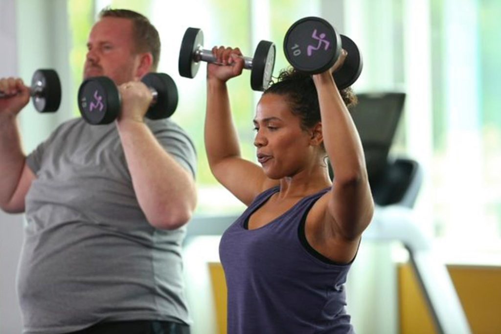 woman working out with dumb bells