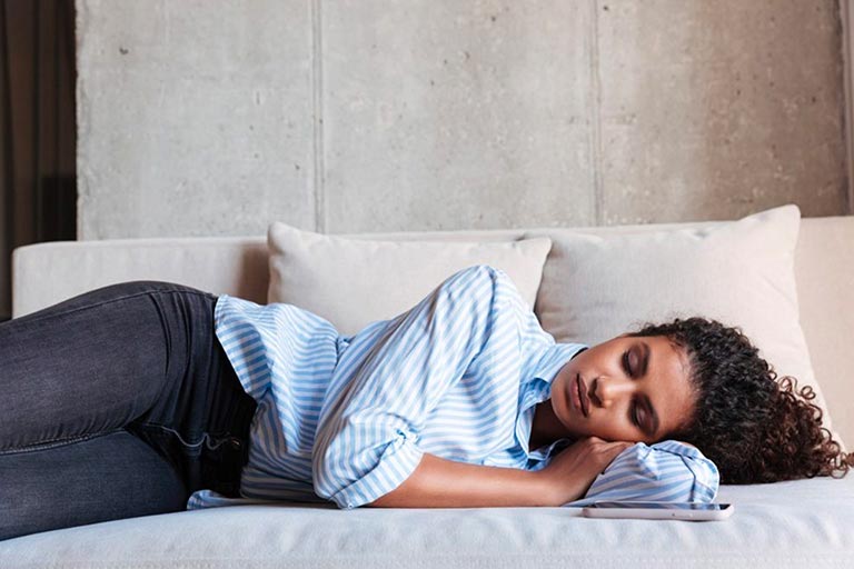 woman laying on couch resting