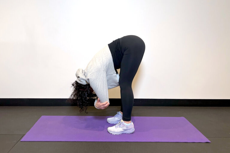 Coach standing on yoga mat