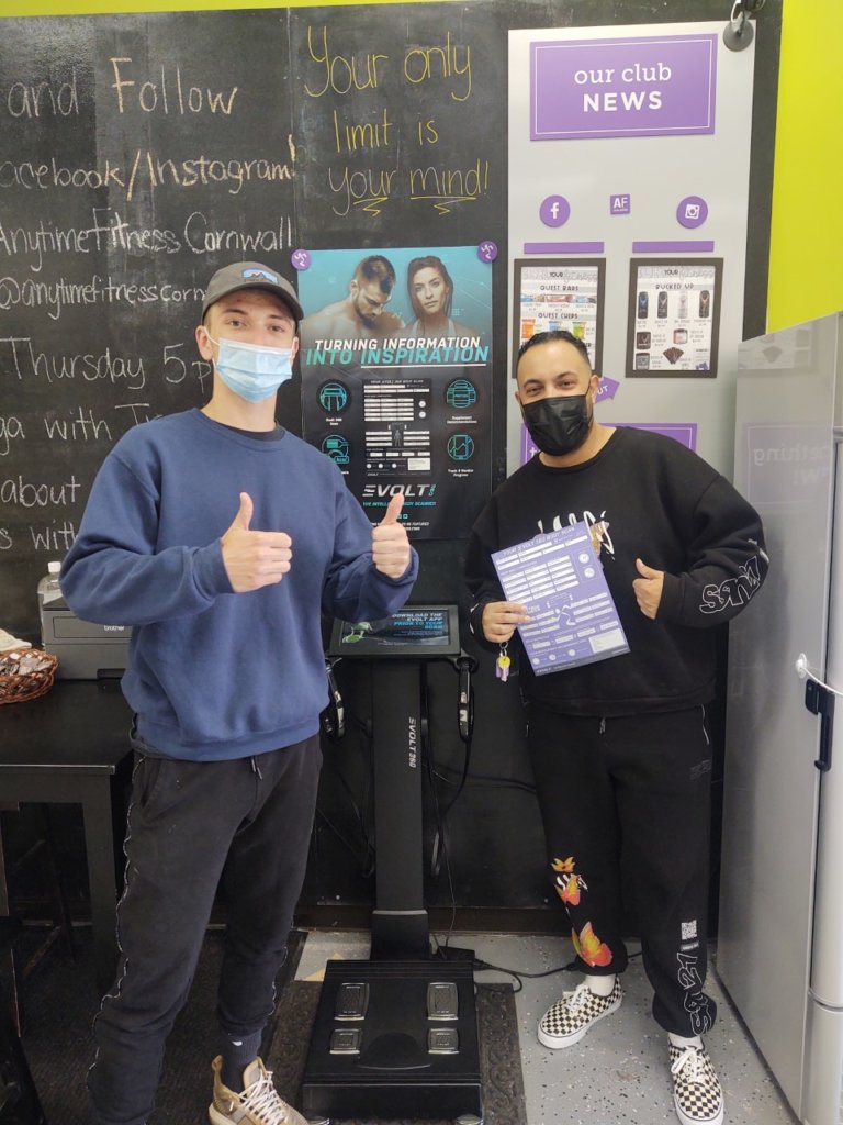 Photo of a member and a coach smiling