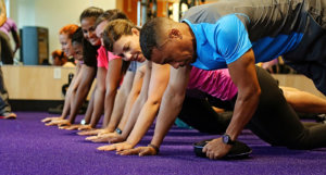 Picture of group of people doing planks in the gym