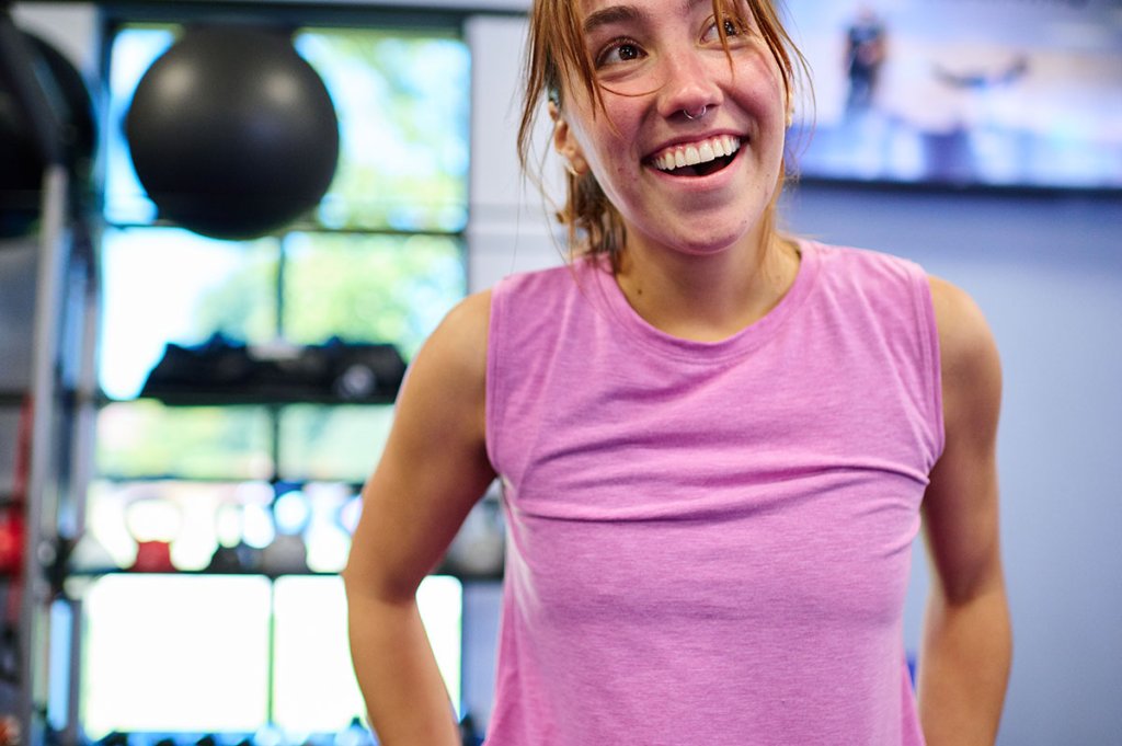 Woman in gym smiling.