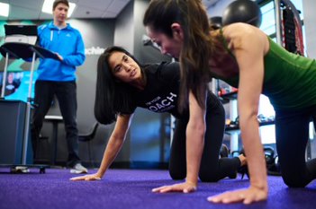 Anytime Fitness Coach Training a Person to Do a Push-Up