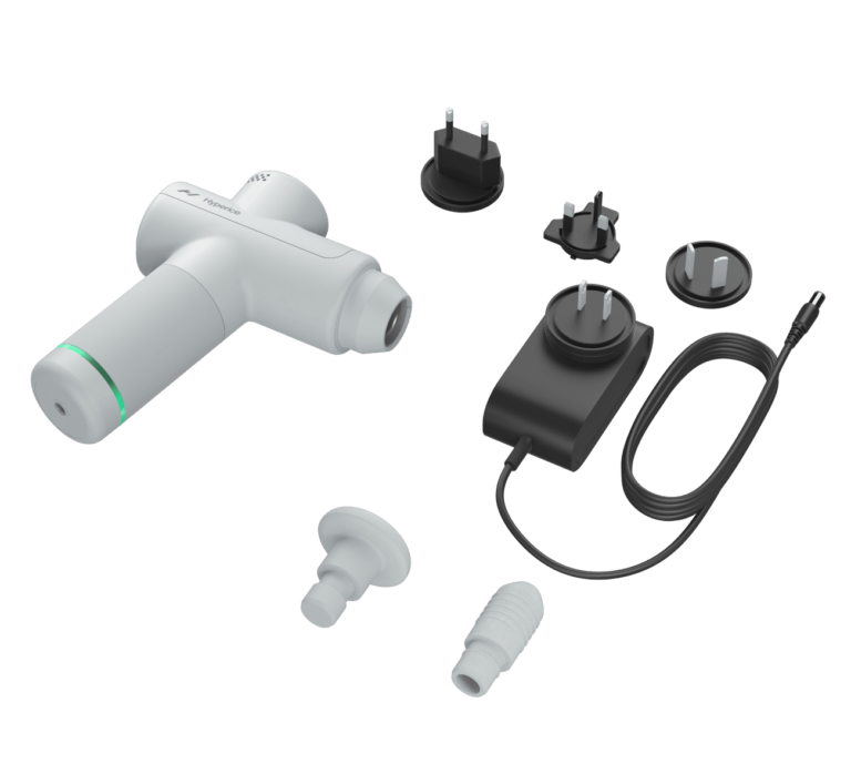 Hypervolt Go 2 model by Hyperice with charging cord, adapters for different outlets, and various shaped attachments including a small ball knob and narrow knob.