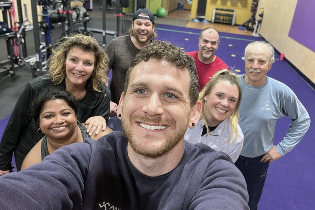 Coach Jesse smiling with his clients.