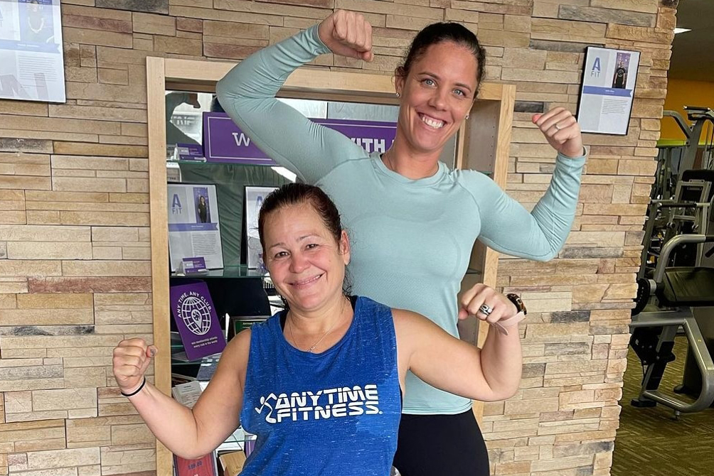 Christy posing and smiling with her Coach.