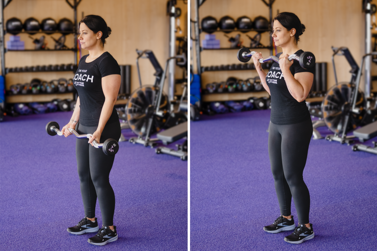 Fitness woman during arms workout in the gym. Standing biceps