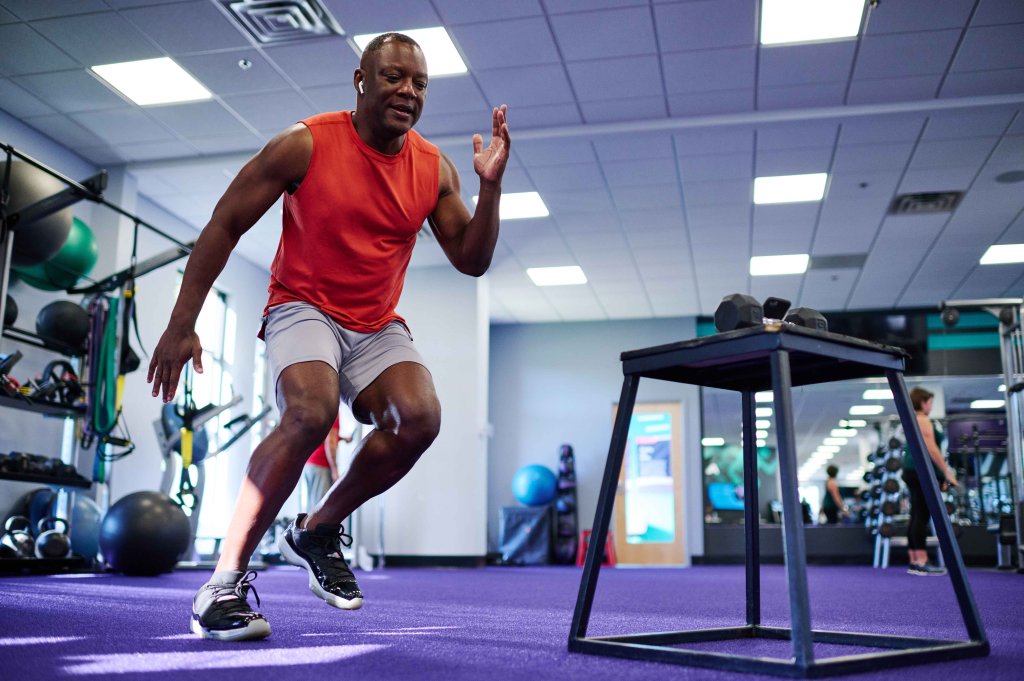 Man doing a cardio workout in a gym.