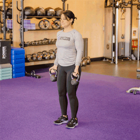Coach performing a dumbbell curl with reverse lunge.