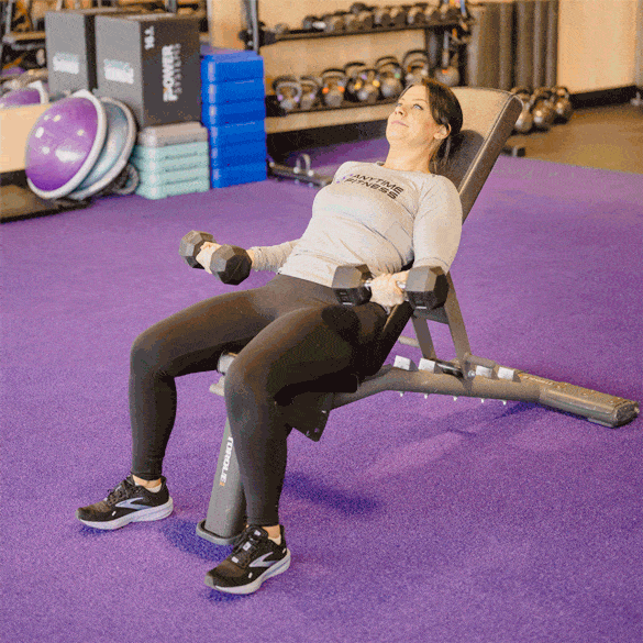 Coach performing a reciprocating incline bicep curl.