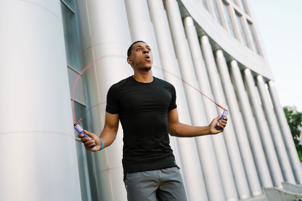 A man jumping rope in an outdoor setting.