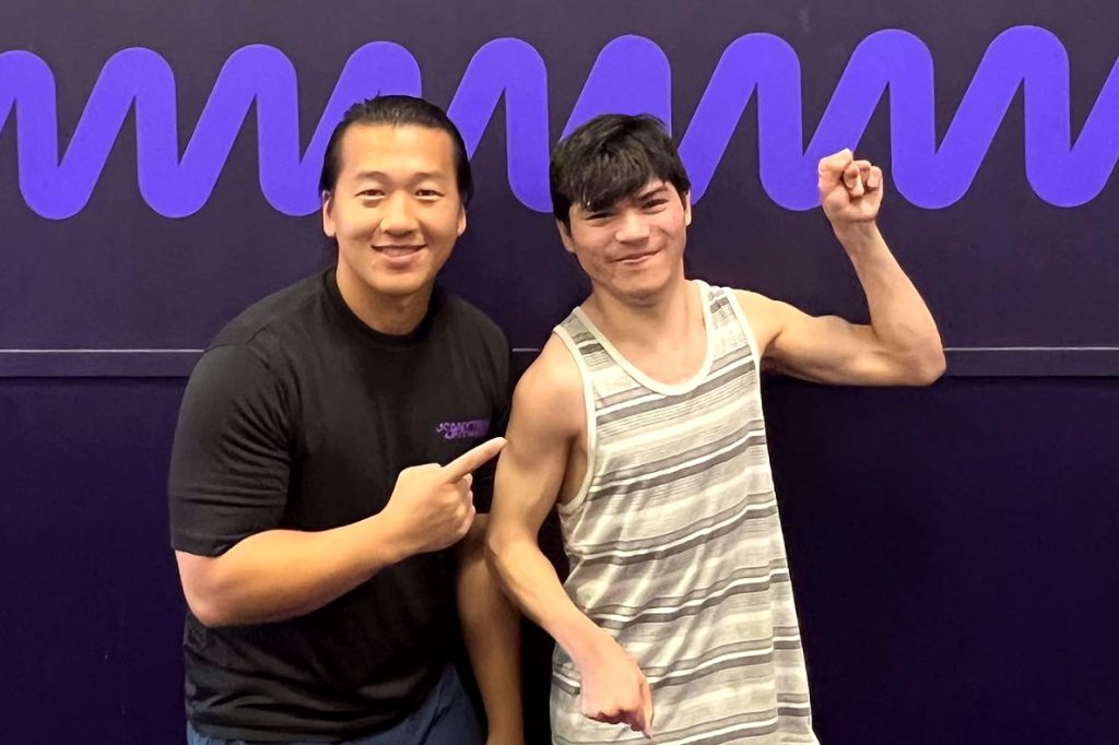 Coach Sou and Stephen posing in the gym.