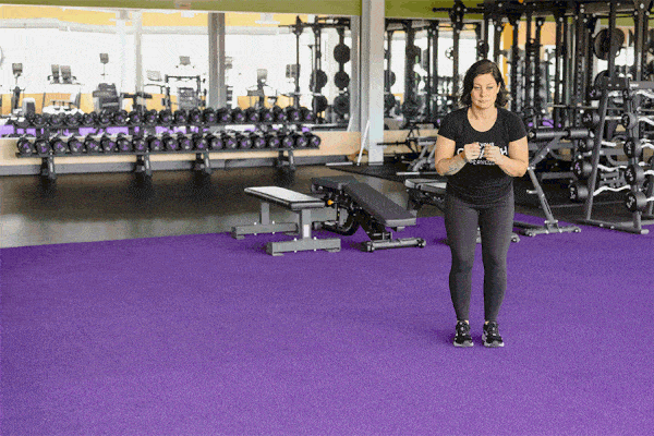 Coach Heather demonstrating a Lateral Bound in a gym setting.