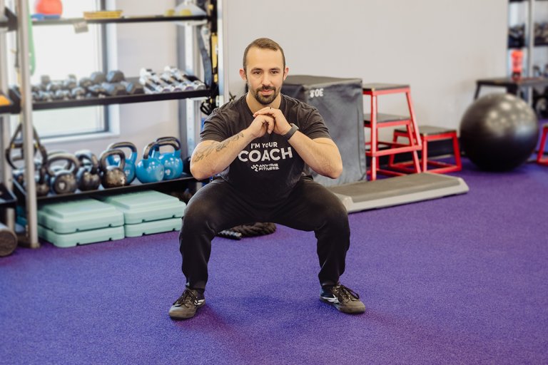 Coach Mike doing a squat move.