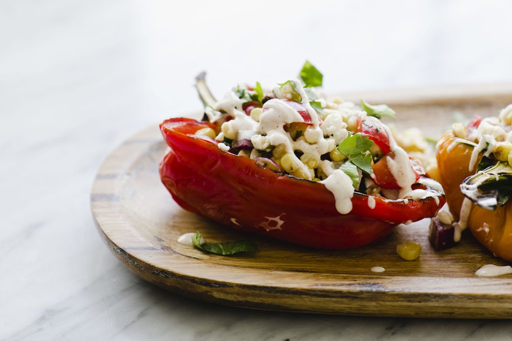 Stuffed red pepper on a plate.