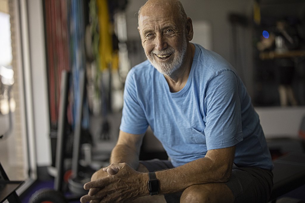 Joe sitting in the gym, smiling.