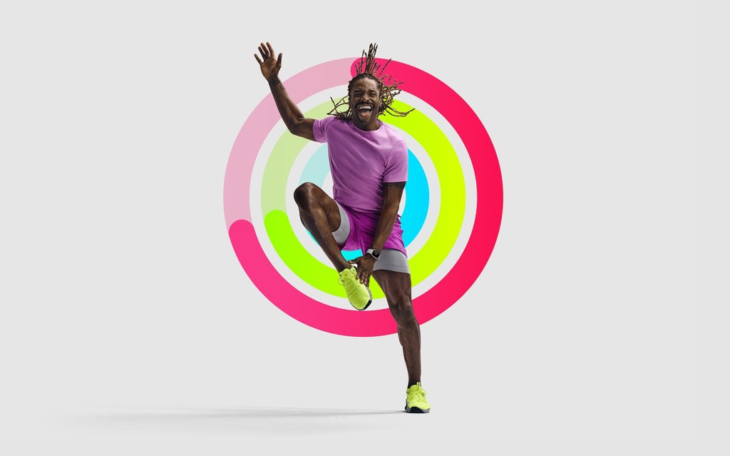 Man jumping with the Apple Fitness+ logo behind him.
