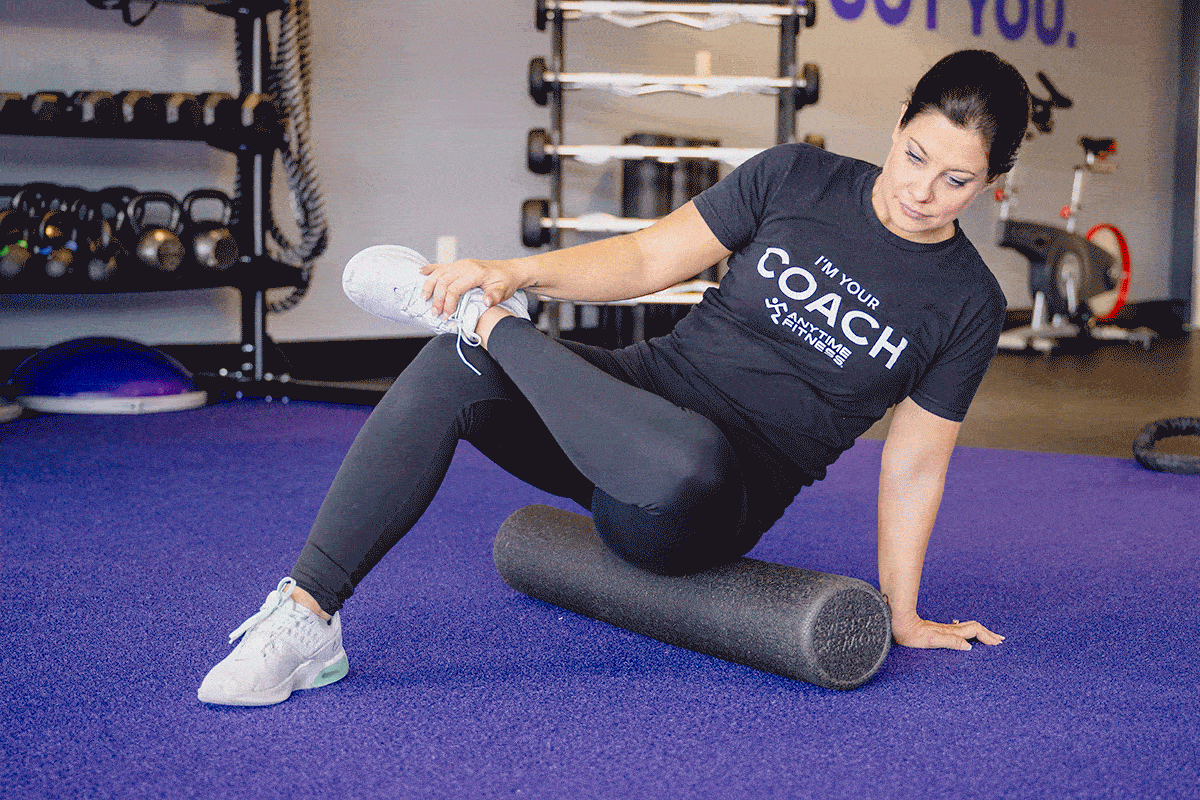 Coach Heather demonstrating foam rolling for the hip flexors.