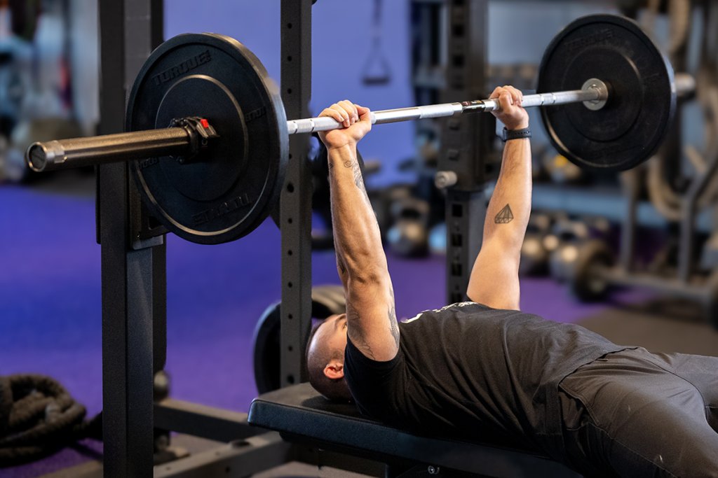 Anytime Fitness Coach Mike demonstrating how to do a flat bench press with proper form.