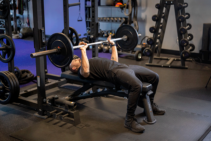 GIF of Anytime Fitness Coach Mike performing a full bench press with a dumbbell.