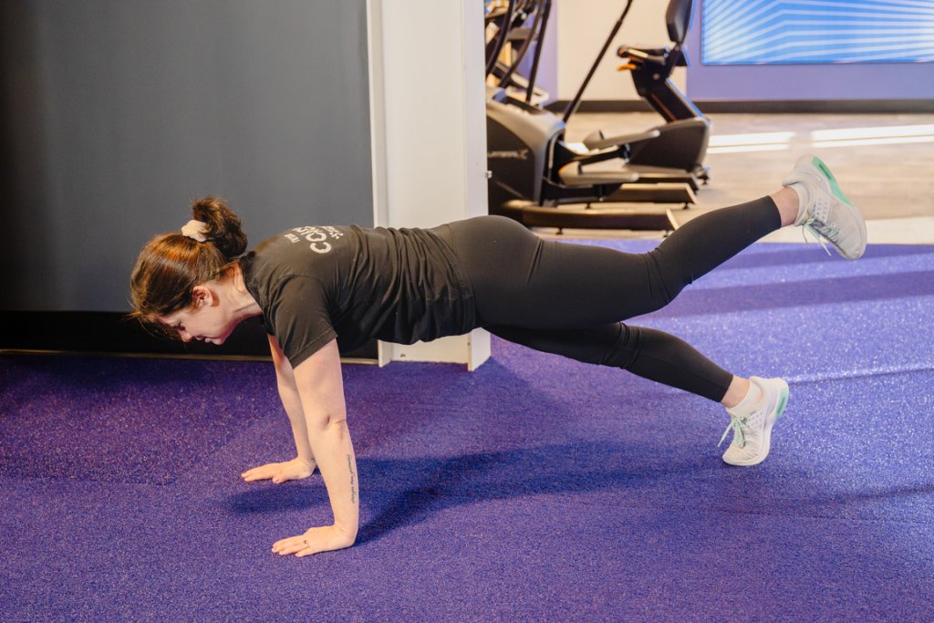 Coach Heather performing a single-leg push-up.