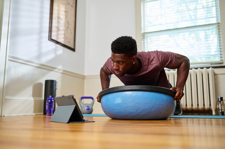 Man working out in living room.