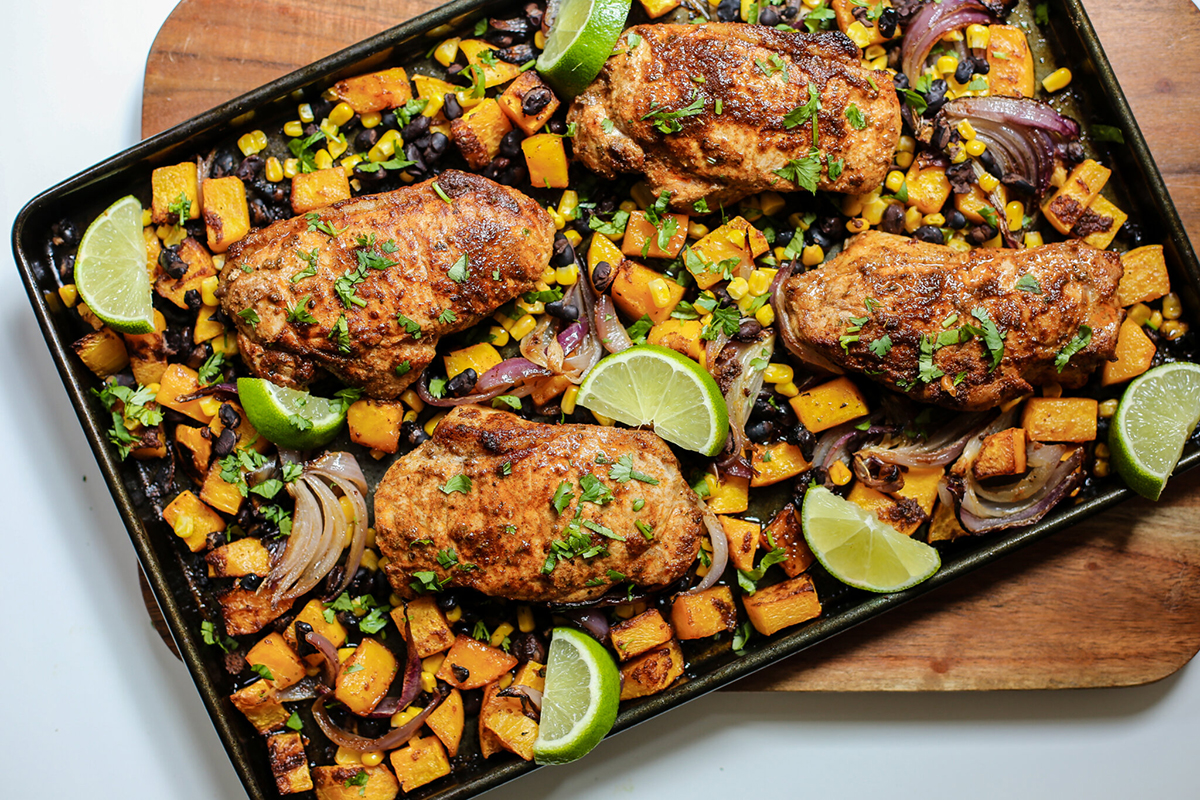 Sheet pan full of southwest pork chops and squash.