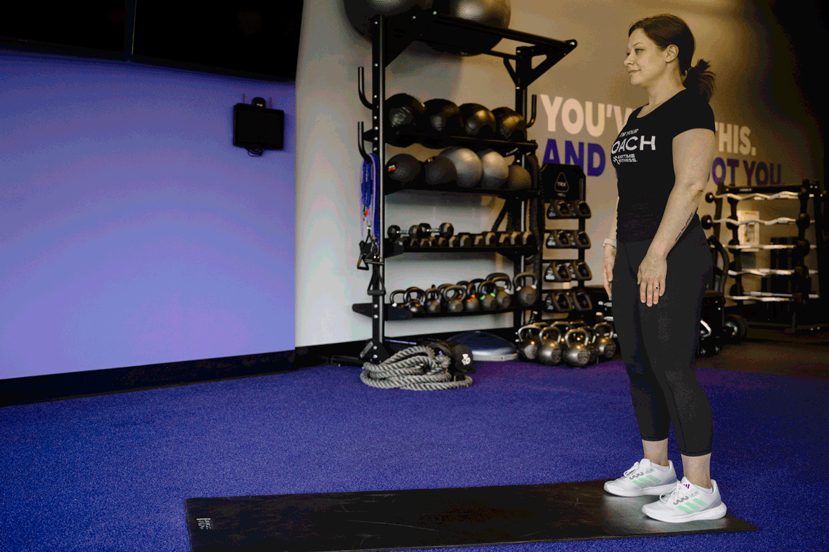 Fitness instructor demonstrates the hand walk press-up exercise for standing and total body flexibility and strength.
