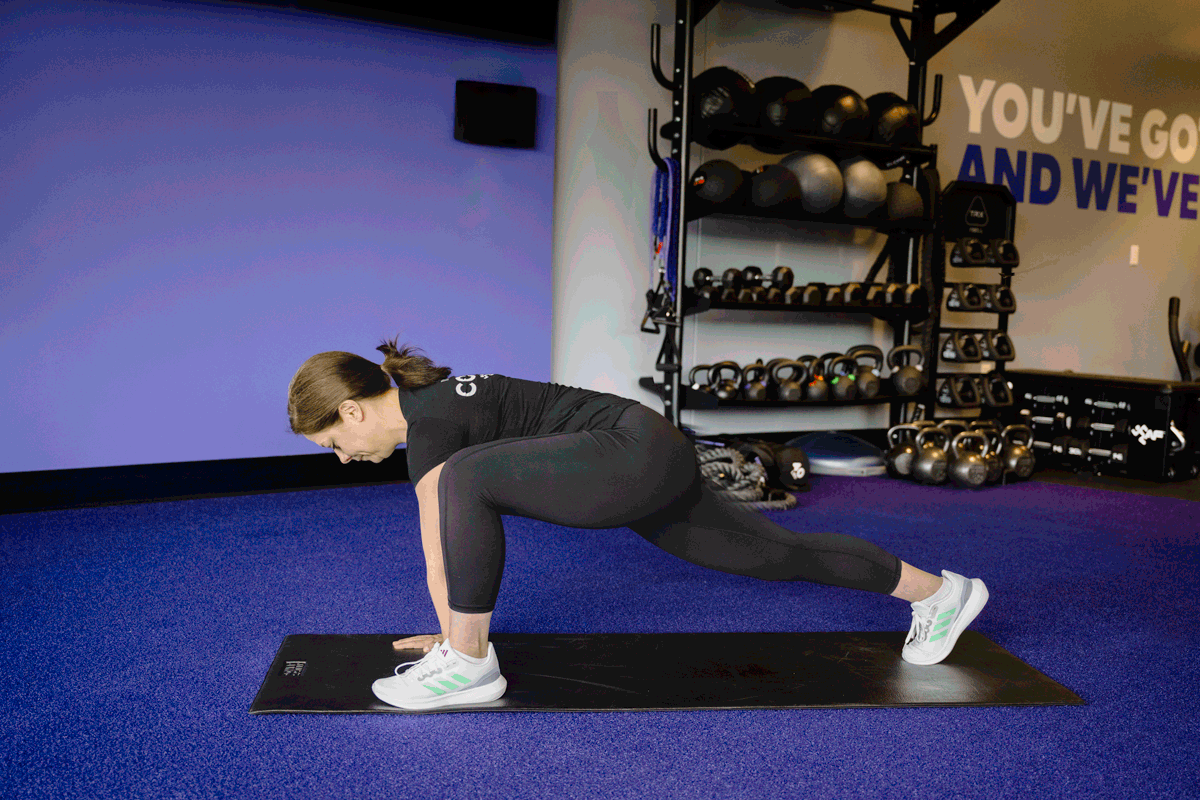 Fitness trainer demonstrating the world's best stretch for overall flexibility and muscle activation in the deep lunge pose.