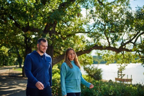 Man and woman taking a walk outside.